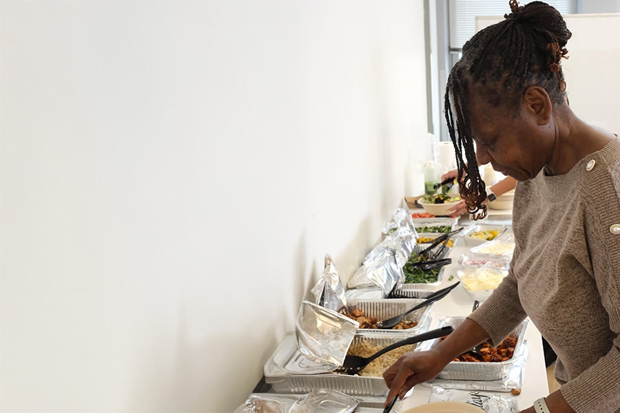 Attendee getting food at buffet